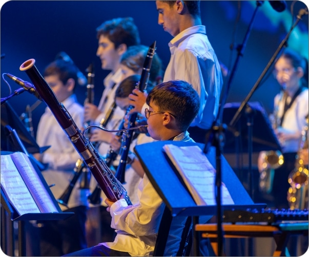 The Conservatory Legacy of Excellence: youth wind ensemble with clarinets bassoons playing sheet music at Yizre'el Gilboa Music Center