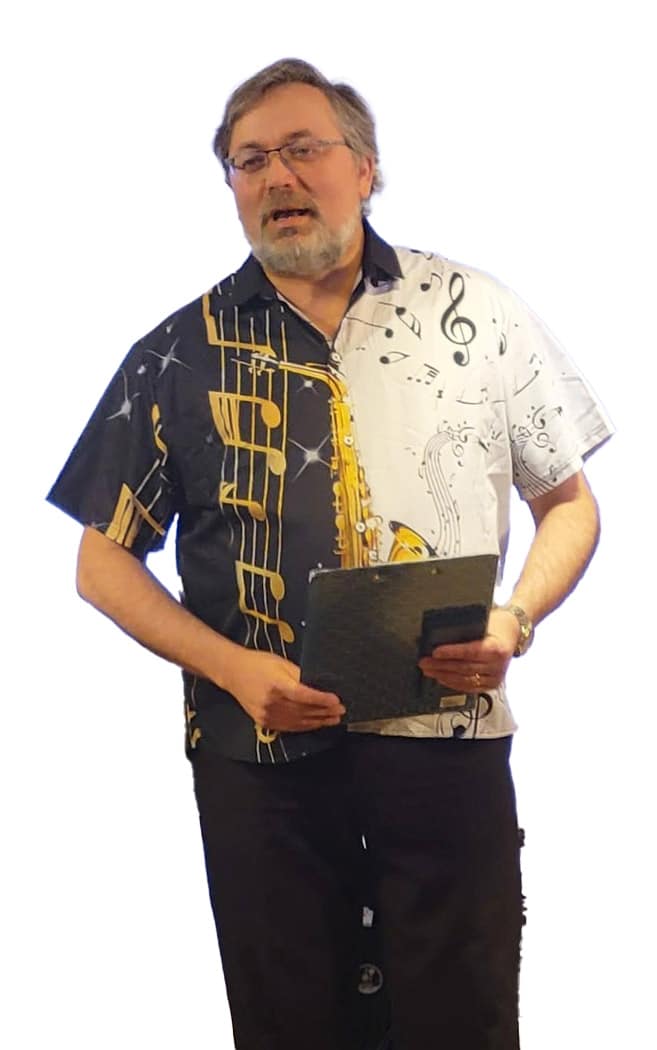 Stas Gavrilov founder portrait: musician educator in patterned shirt beside "The Man Behind the Music" at Yizre'el Gilboa Music Center